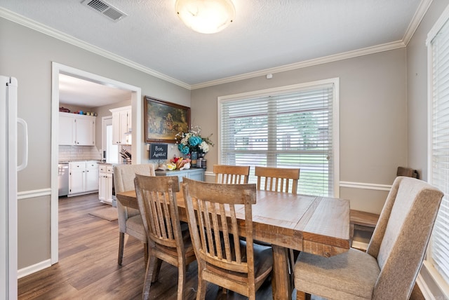 40 High Timber Dr, Maumelle, AR 72113 - dining room featuring wood finished floors, ornamental molding, and a textured ceiling