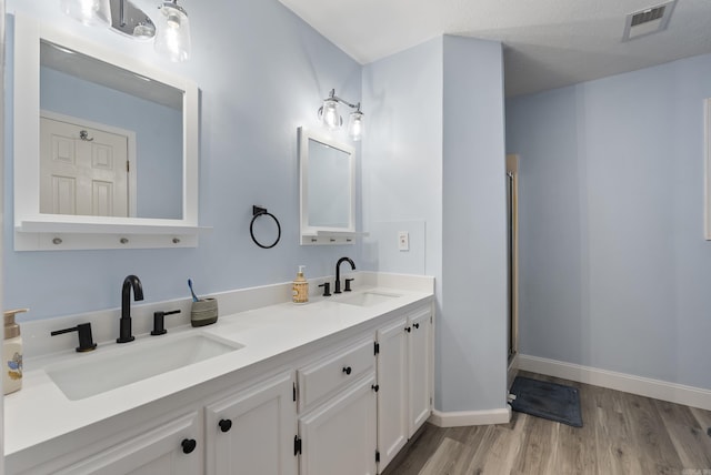 40 High Timber Dr, Maumelle, AR 72113 - full bathroom with wood finished floors, a shower stall, double vanity, and baseboards