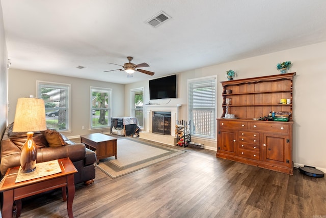 40 High Timber Dr, Maumelle, AR 72113 - living area with dark wood-type flooring, a ceiling fan, and a fireplace with raised hearth