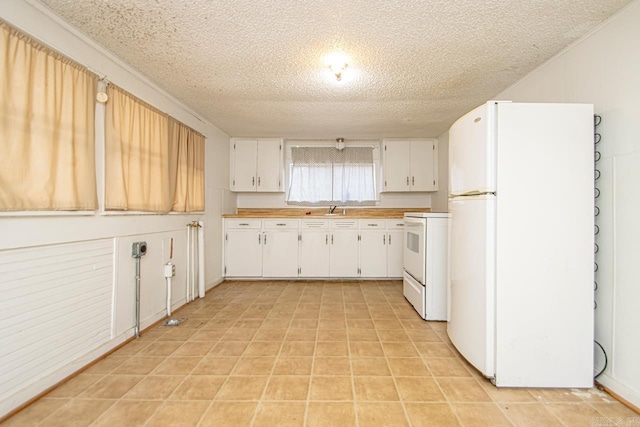 1523 W 46, North Little Rock, AR 72118 - kitchen featuring white appliances, a sink, a textured ceiling, white cabinetry, and light countertops