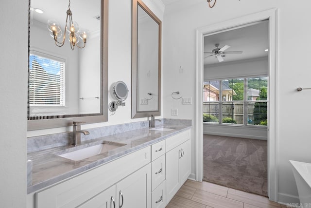 425 Valley Ranch Cir, Little Rock, AR 72223 - bathroom featuring ornamental molding, a chandelier, double vanity, a ceiling fan, and baseboards