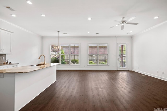 425 Valley Ranch Cir, Little Rock, AR 72223 - unfurnished living room featuring a sink, dark wood finished floors, recessed lighting, baseboards, and crown molding