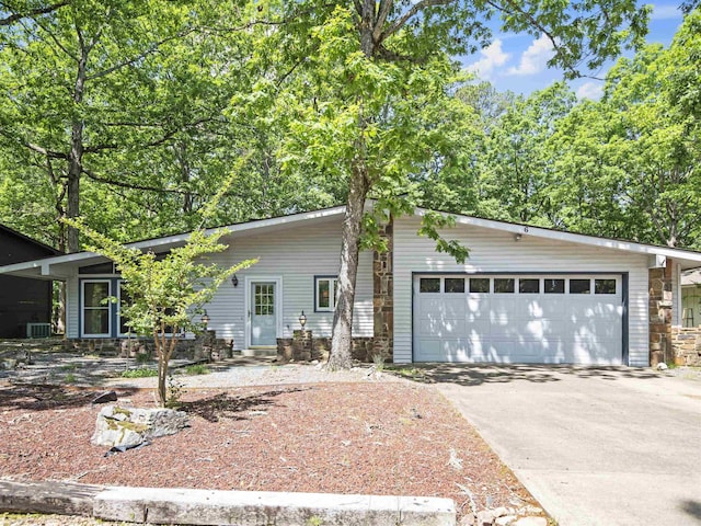 6 Sierra Ln, Hot Springs Village, AR 71909 - mid-century inspired home featuring concrete driveway, an attached garage, and stone siding
