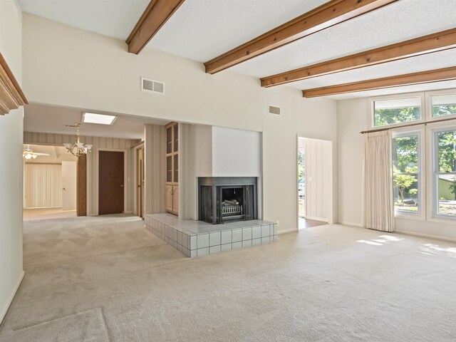 6 Sierra Ln, Hot Springs Village, AR 71909 - unfurnished living room featuring light colored carpet, a tile fireplace, a chandelier, and beam ceiling
