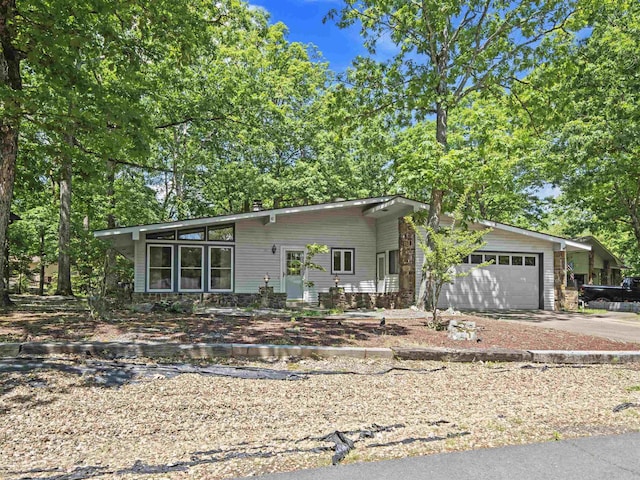 6 Sierra Ln, Hot Springs Village, AR 71909 - mid-century modern home featuring concrete driveway, a garage, and a chimney