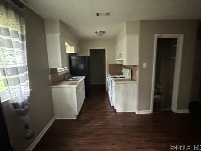3509 Arapaho Trl, Little Rock, AR 72209 - kitchen with electric stove, light countertops, white cabinetry, and dark wood finished floors