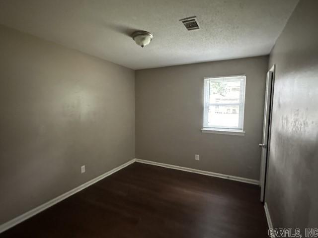 3509 Arapaho Trl, Little Rock, AR 72209 - empty room with dark wood finished floors and baseboards