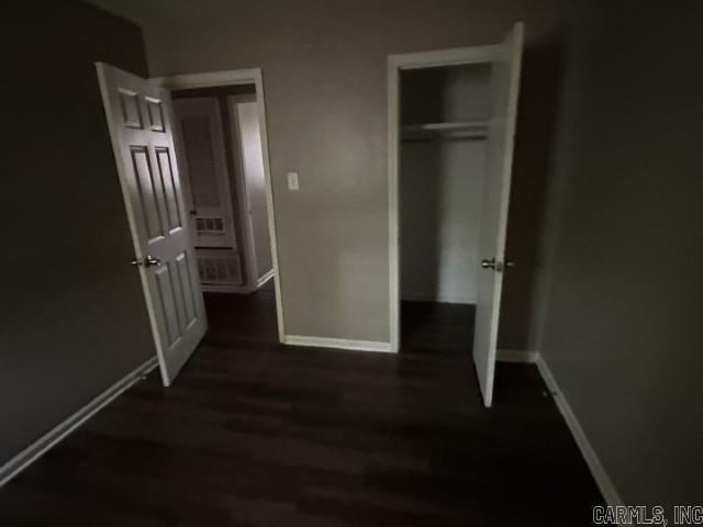 3509 Arapaho Trl, Little Rock, AR 72209 - unfurnished bedroom featuring baseboards, wood finished floors, and a closet
