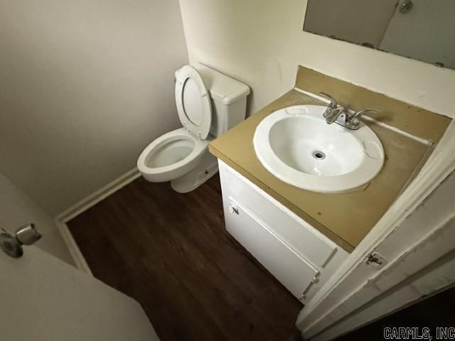3509 Arapaho Trl, Little Rock, AR 72209 - bathroom with vanity, toilet, wood finished floors, and baseboards