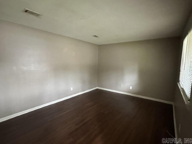 3509 Arapaho Trl, Little Rock, AR 72209 - empty room featuring dark wood-style floors and baseboards