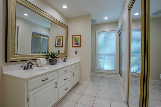 6220 Hopi Dr, North Little Rock, AR 72116 - bathroom featuring tile patterned flooring, baseboards, double vanity, toilet, and recessed lighting