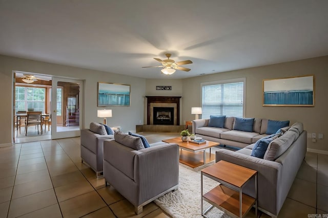 6220 Hopi Dr, North Little Rock, AR 72116 - living area with a ceiling fan, healthy amount of natural light, light tile patterned flooring, and a fireplace