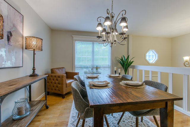 6220 Hopi Dr, North Little Rock, AR 72116 - dining room with a chandelier and light wood finished floors