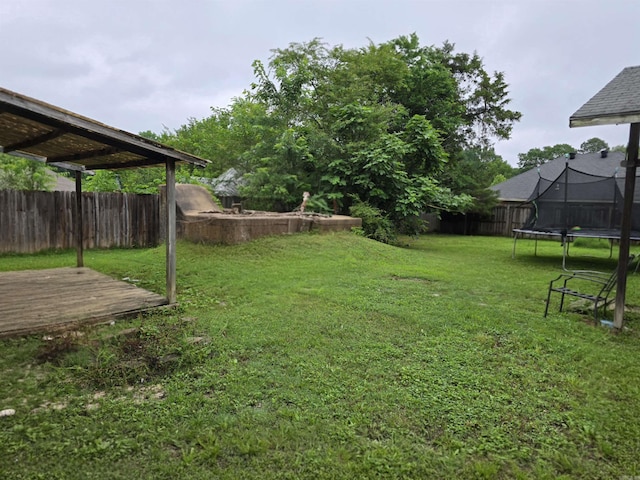 1020 Pioneer Rd, Searcy, AR 72143 - view of yard featuring a trampoline and a wooden deck