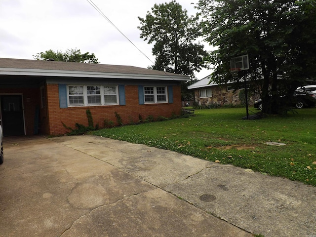 1020 Pioneer Rd, Searcy, AR 72143 - view of side of property with a yard, brick siding, a carport, and concrete driveway
