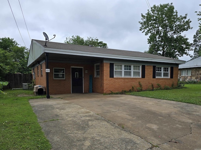 1020 Pioneer Rd, Searcy, AR 72143 - view of front of property with driveway, brick siding, and a carport