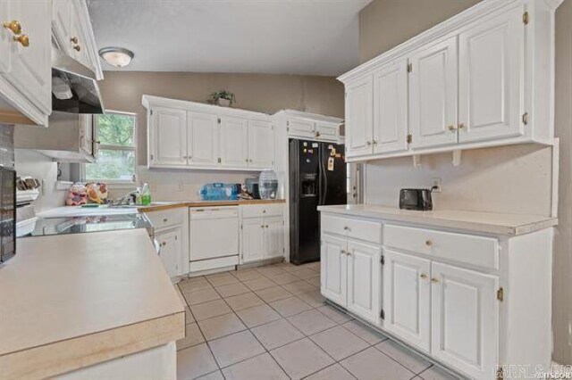 503 Westpine Dr, Hot Springs, AR 71913 - kitchen with white dishwasher, black fridge, light tile patterned floors, white cabinetry, and vaulted ceiling
