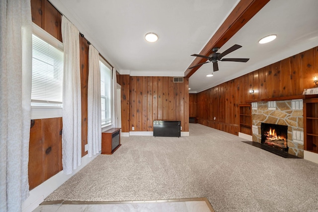 169 Crest St, Hot Springs, AR 71901 - unfurnished living room with wooden walls, ceiling fan, carpet flooring, a stone fireplace, and ornamental molding