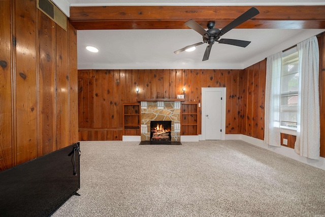 169 Crest St, Hot Springs, AR 71901 - unfurnished living room with carpet, wooden walls, ceiling fan, a stone fireplace, and recessed lighting