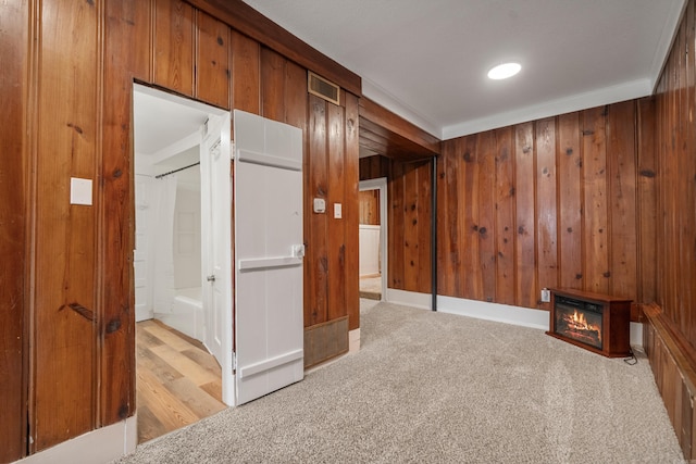 169 Crest St, Hot Springs, AR 71901 - unfurnished bedroom featuring wood walls, a glass covered fireplace, carpet floors, and connected bathroom