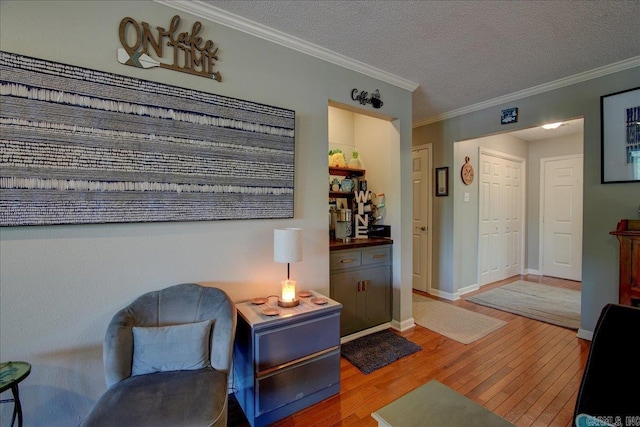 1201 Airport Rd Unit C12, Hot Springs, AR 71913 - sitting room with wood finished floors, crown molding, a textured ceiling, and baseboards