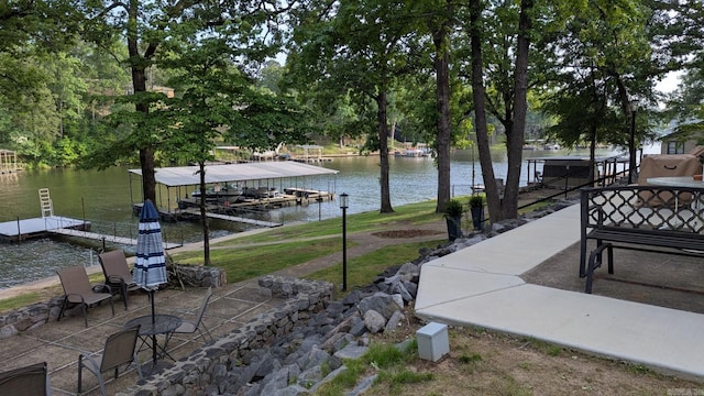 1201 Airport Rd Unit C12, Hot Springs, AR 71913 - view of patio featuring a floating dock, a water view, and view of wooded area