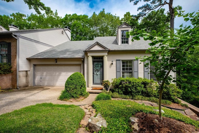 3501 Oakwood Rd Unit 9, Little Rock, AR 72202 - view of front of house featuring asphalt driveway, a garage, and a chimney