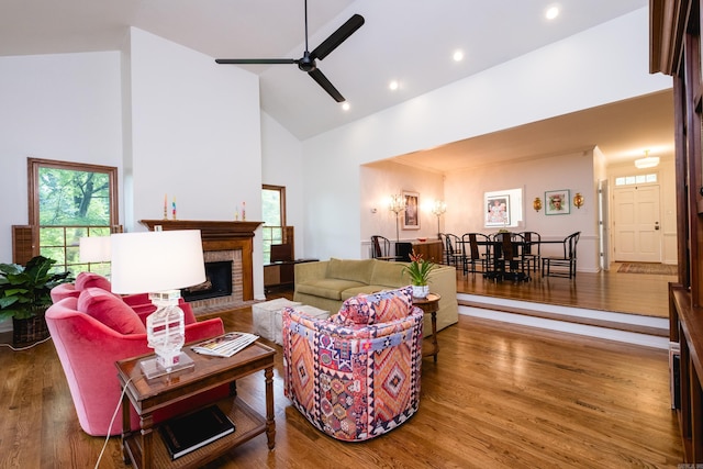 3501 Oakwood Rd Unit 9, Little Rock, AR 72202 - living area featuring high vaulted ceiling, a brick fireplace, wood finished floors, a ceiling fan, and recessed lighting