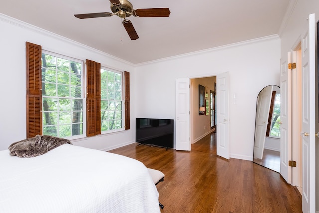 3501 Oakwood Rd Unit 9, Little Rock, AR 72202 - bedroom featuring crown molding, wood finished floors, baseboards, a ceiling fan, and arched walkways