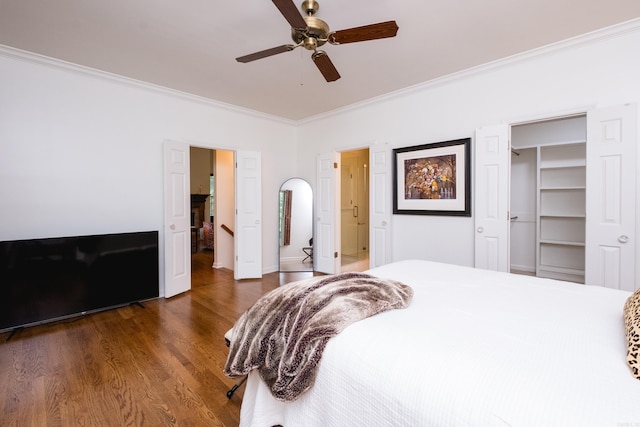 3501 Oakwood Rd Unit 9, Little Rock, AR 72202 - bedroom with crown molding, dark wood finished floors, a ceiling fan, and a walk in closet
