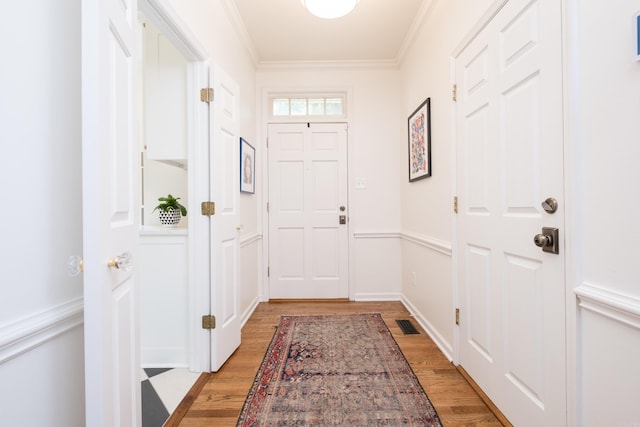 3501 Oakwood Rd Unit 9, Little Rock, AR 72202 - doorway to outside featuring light wood finished floors and crown molding