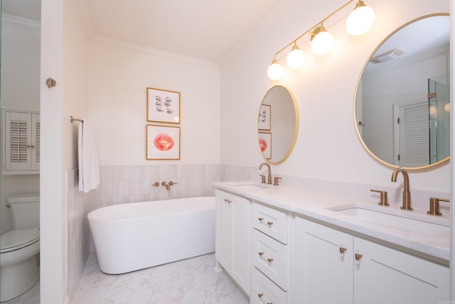 3501 Oakwood Rd Unit 9, Little Rock, AR 72202 - bathroom featuring crown molding, marble finish floors, toilet, a freestanding bath, and double vanity