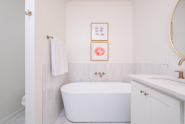 3501 Oakwood Rd Unit 9, Little Rock, AR 72202 - bathroom with a freestanding tub, marble finish floors, vanity, toilet, and tile walls