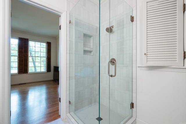 3501 Oakwood Rd Unit 9, Little Rock, AR 72202 - bathroom with ornamental molding, baseboards, a stall shower, and wood finished floors