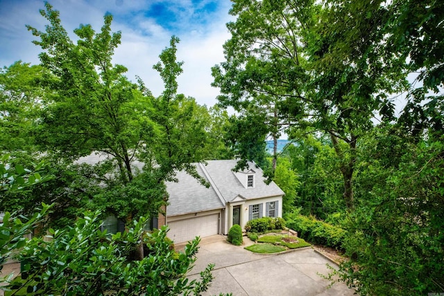 3501 Oakwood Rd Unit 9, Little Rock, AR 72202 - view of front of house with concrete driveway, an attached garage, brick siding, and roof with shingles