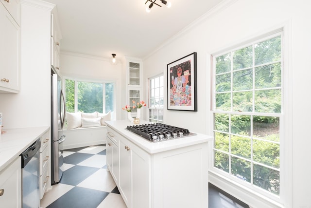 3501 Oakwood Rd Unit 9, Little Rock, AR 72202 - kitchen with tile patterned floors, stainless steel appliances, plenty of natural light, light countertops, and crown molding