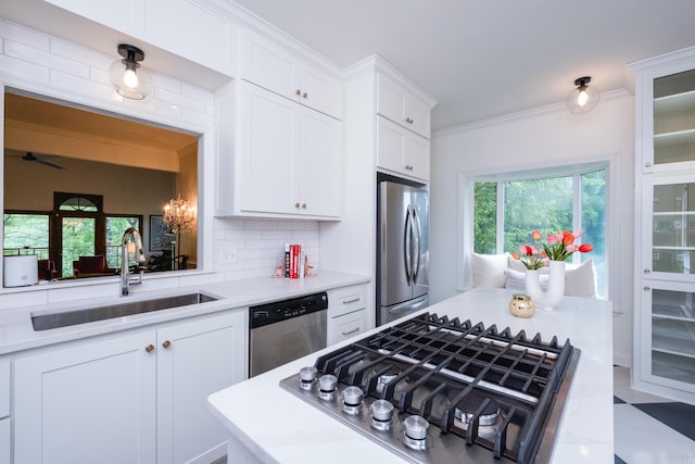 3501 Oakwood Rd Unit 9, Little Rock, AR 72202 - kitchen featuring stainless steel appliances, a sink, white cabinetry, tasteful backsplash, and glass insert cabinets