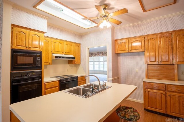 4 Hunter Ct, Little Rock, AR 72211 - kitchen with black appliances, a sink, under cabinet range hood, wallpapered walls, and ornamental molding