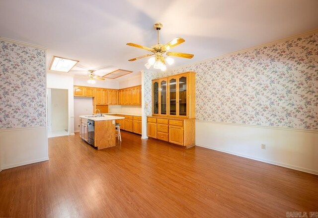 4 Hunter Ct, Little Rock, AR 72211 - kitchen featuring a wainscoted wall, ceiling fan, a sink, wallpapered walls, and light countertops