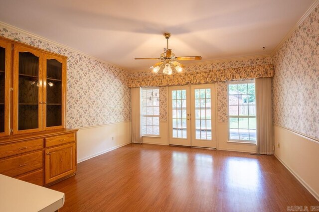 4 Hunter Ct, Little Rock, AR 72211 - unfurnished dining area with wood finished floors, a ceiling fan, ornamental molding, a wainscoted wall, and wallpapered walls
