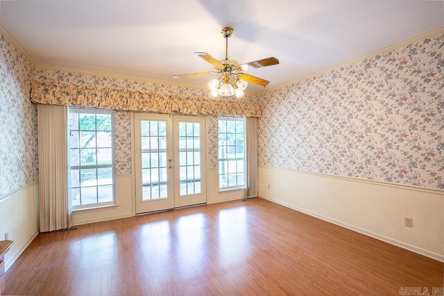 4 Hunter Ct, Little Rock, AR 72211 - spare room featuring a wainscoted wall, wood finished floors, crown molding, plenty of natural light, and wallpapered walls