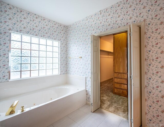 4 Hunter Ct, Little Rock, AR 72211 - full bath featuring wallpapered walls, a tub with jets, tile patterned floors, and a spacious closet