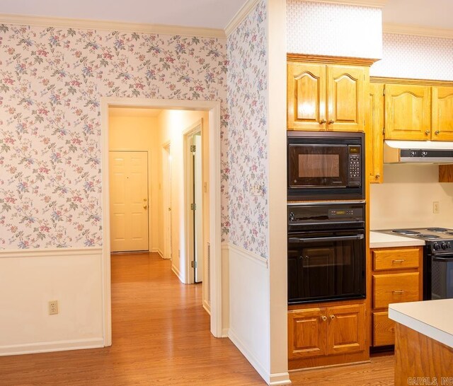 4 Hunter Ct, Little Rock, AR 72211 - kitchen with black appliances, wallpapered walls, a wainscoted wall, under cabinet range hood, and light wood-style flooring