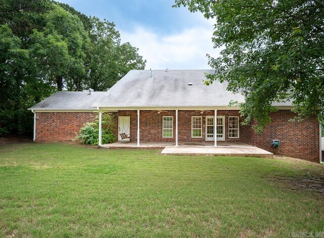 4 Hunter Ct, Little Rock, AR 72211 - back of house featuring a patio area, a lawn, and brick siding