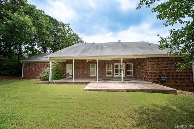4 Hunter Ct, Little Rock, AR 72211 - back of house with a lawn, a patio, and brick siding