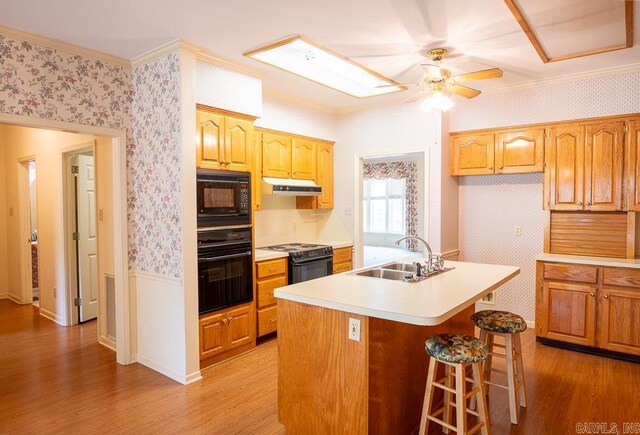 4 Hunter Ct, Little Rock, AR 72211 - kitchen with a sink, black appliances, wallpapered walls, under cabinet range hood, and ornamental molding