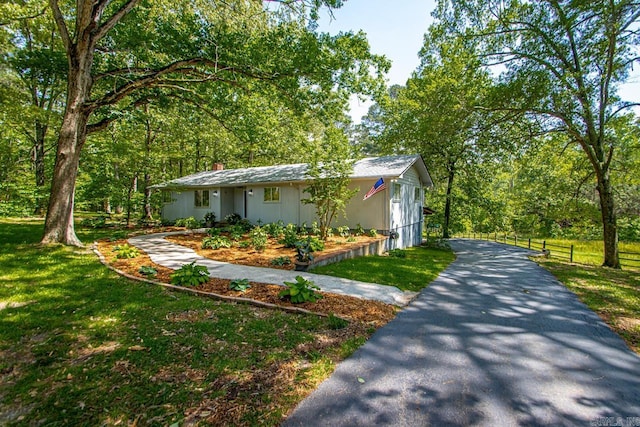 9425 Hogue Rd, Mabelvale, AR 72103 - view of front facade featuring driveway, a chimney, and board and batten siding