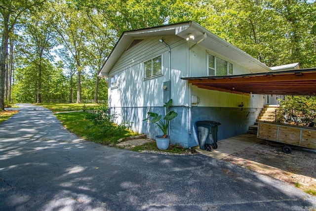 9425 Hogue Rd, Mabelvale, AR 72103 - view of side of property with driveway and a carport