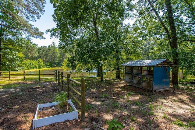 9425 Hogue Rd, Mabelvale, AR 72103 - view of yard with exterior structure, an outbuilding, and a garden