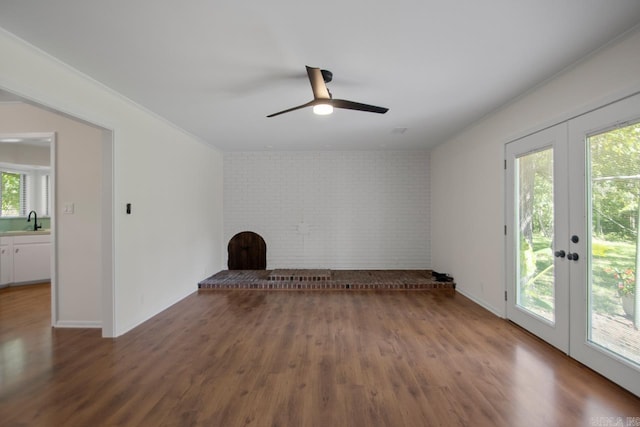 9425 Hogue Rd, Mabelvale, AR 72103 - empty room with a sink, brick wall, wood finished floors, a ceiling fan, and french doors